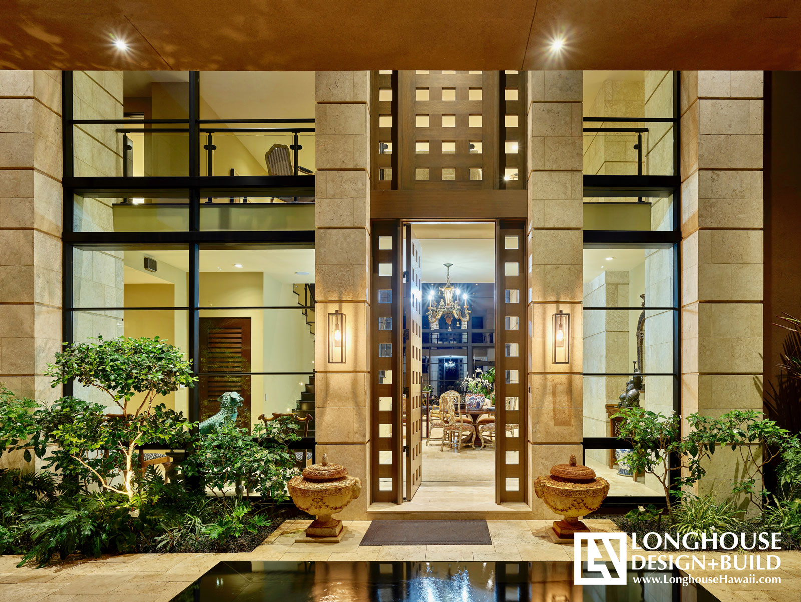 Hawaii, Lanikai dramatic two story white oak entry doors, coral columns and contemporary metal framed storefront windows Jeff Long LonghouseHawaii Hawaii Architect